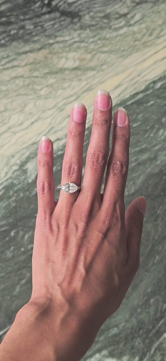 Ganga east-west marquise diamond solitaire ring, close-up, worn on hand